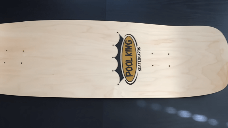 white pool shape skateboard deck with text pool king skateboards