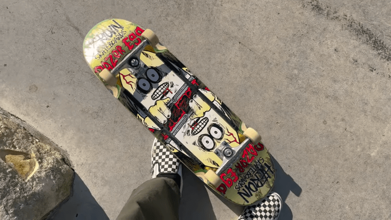 yellow egg shaped skateboard deck on the floor